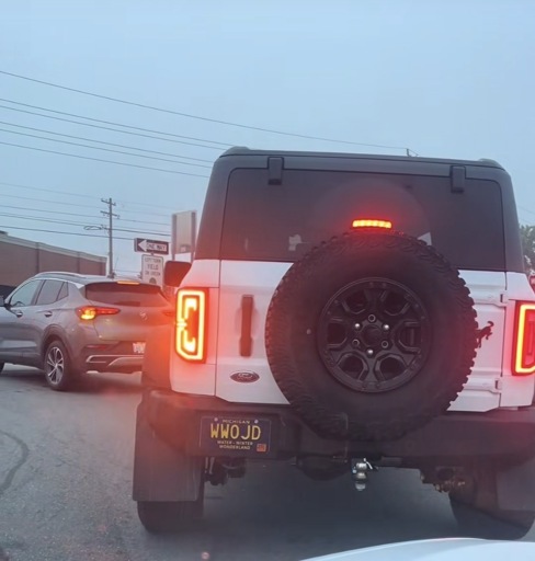 A white Ford bronco with the license plate WWOJD